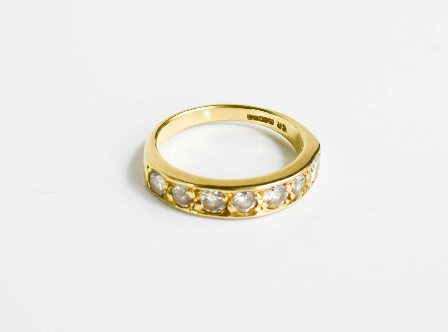 Lot 153 - An 18ct gold and diamond seven stone ring.
