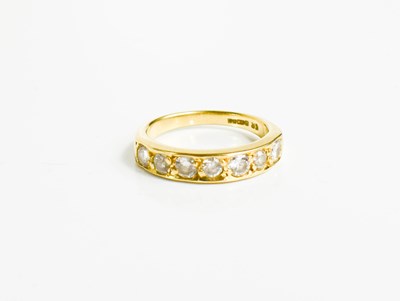 Lot 153 - An 18ct gold and diamond seven stone ring.