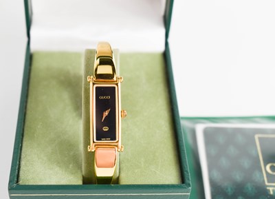 Lot 77 - A Ladies Gucci cocktail watch, complete with...