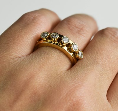 Lot 175 - A 18ct gold and diamond five stone ring, the...