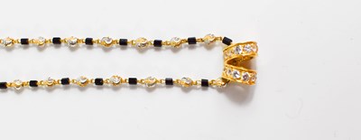 Lot 99 - An Indian 22ct gold and paste necklace.