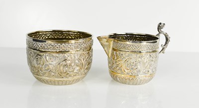 Lot 400 - A silver milk jug and sugar bowl, decorated...