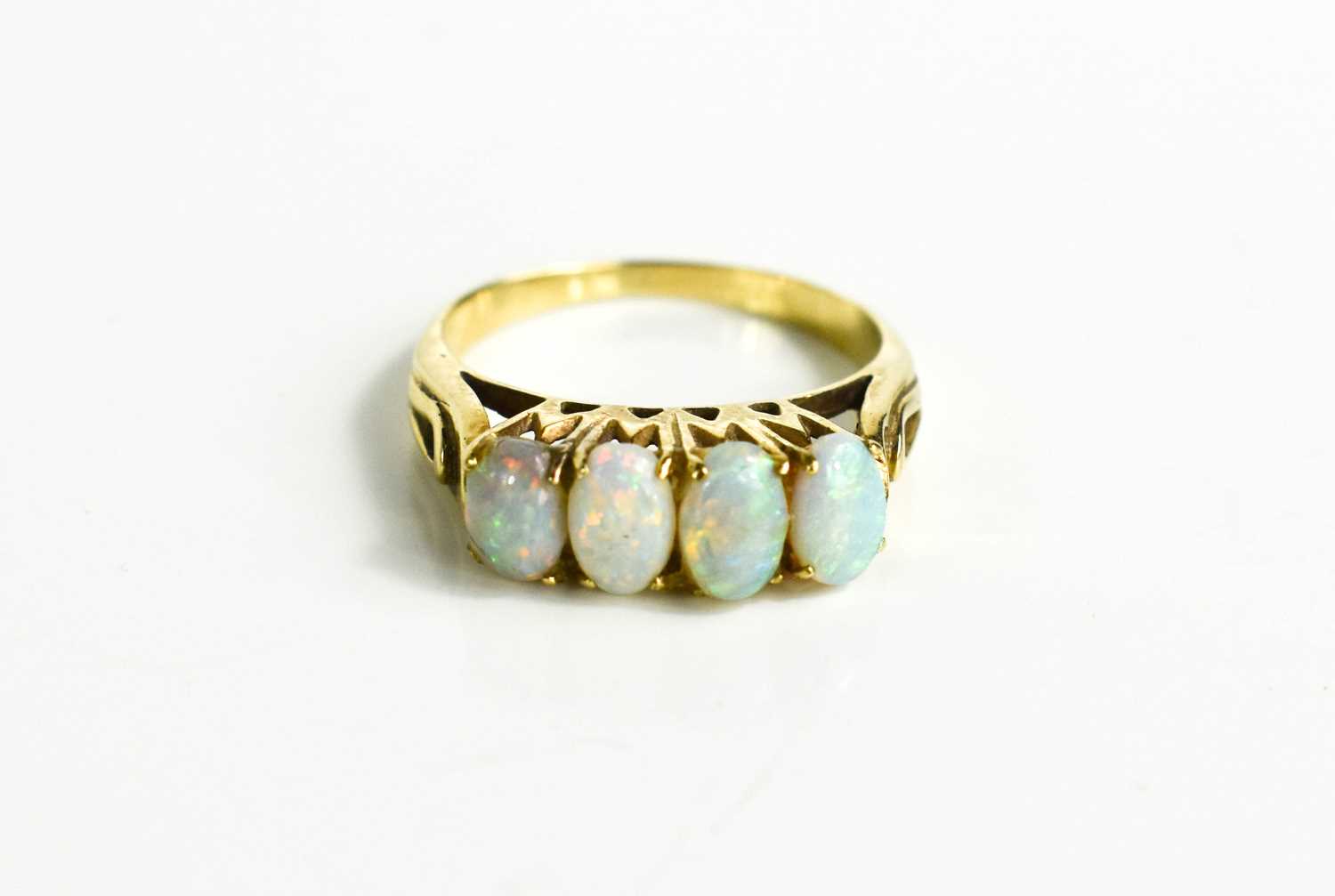 Lot 85 - A gold (unmarked) and opal ring, the four oval...