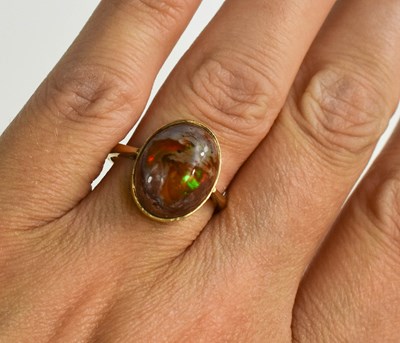 Lot 12 - A 9ct gold and fire opal ring, size O, 4.2g.