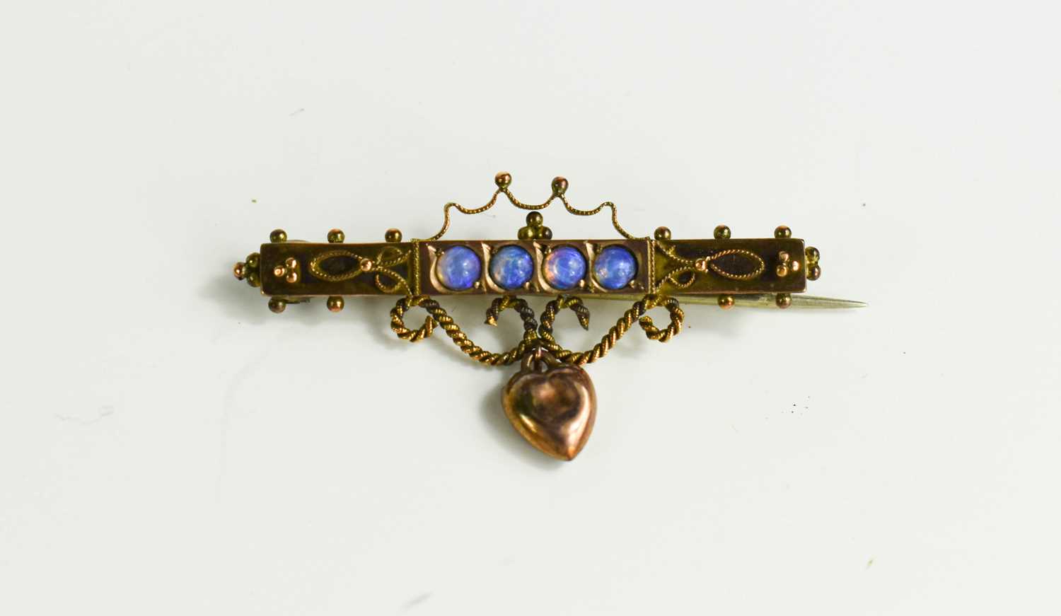 Lot 58 - A 9ct rose gold and opal set sweetheart brooch,...