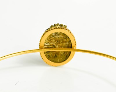 Lot 39 - A 14ct gold Egyptian bangle, with a stone...