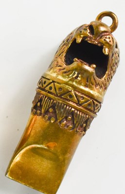 Lot 569 - A small brass pendant whistle, in the form of...