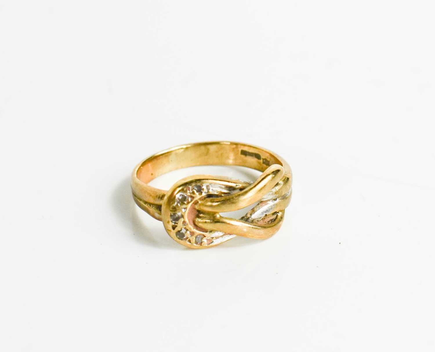 Lot 31 - A 9ct gold and diamond set knot ring, size I,...