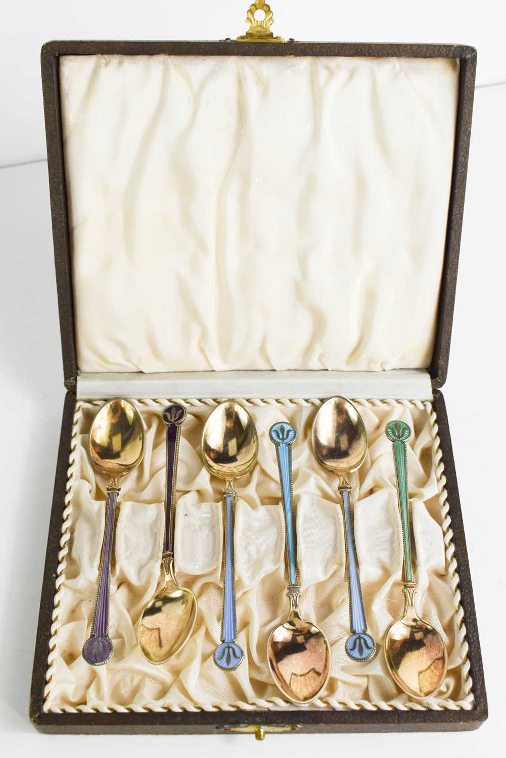 Lot 386 - A set of silver and enamelled tea spoons by...