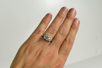 Lot 49 - A platinum and diamond cluster ring, by Dawson...