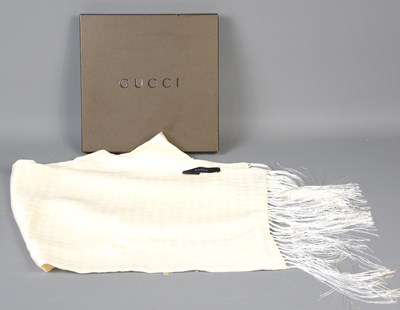 Lot 586 - A Gucci cream silk scarf with silk knotted...