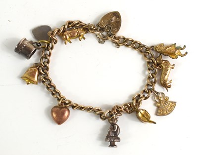 Lot 230 - A silver charm bracelet with various charms to...