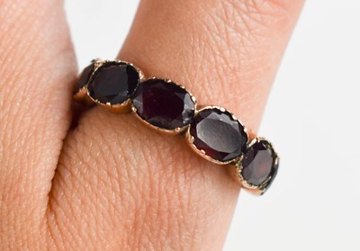 Lot 22 - A Georgian rose gold (tested as) and garnet...
