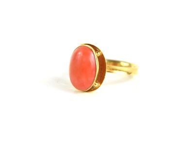 Lot 224 - A 9ct gold [tested as] and coral cabochon ring,...