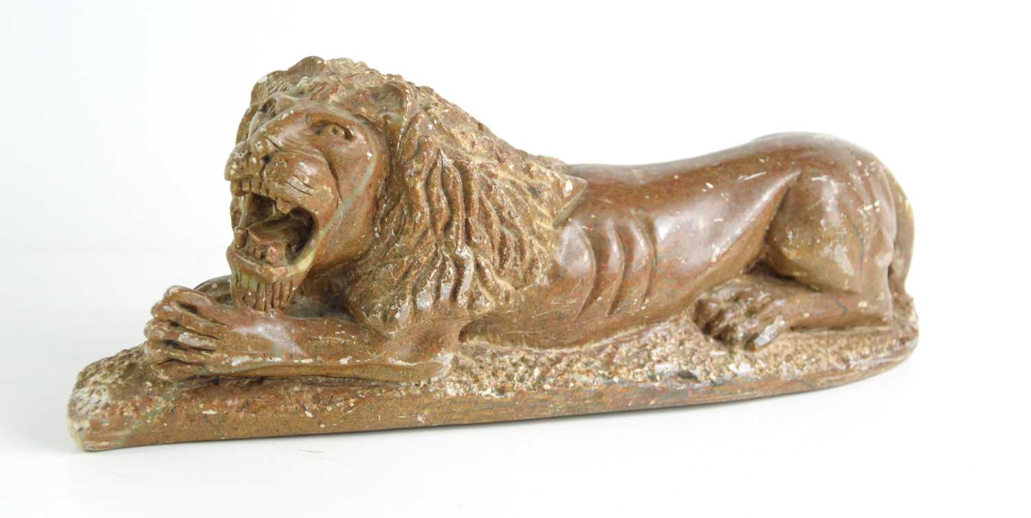 Lot 197 - A Chinese carved soapstone Lion lying down,...