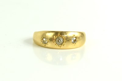 Lot 198 - An 18ct gold and diamond three stone ring,...