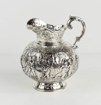 Lot 156 - A continental silver jug, embossed with putti...