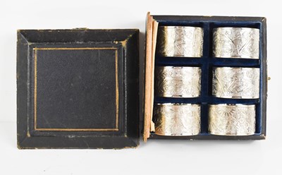 Lot 140 - A set of six Chinese white metal napkin rings,...
