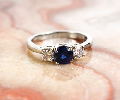 Lot 194 - A platinum, sapphire and diamond trilogy ring,...