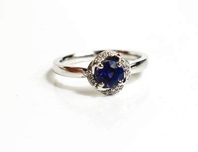 Lot 223 - An 18ct white gold, sapphire and diamond ring,...