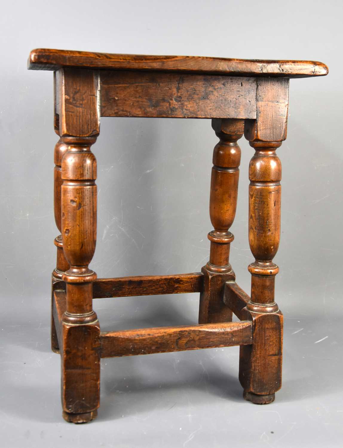 Lot 581 - An early 18th century oak joint stool.