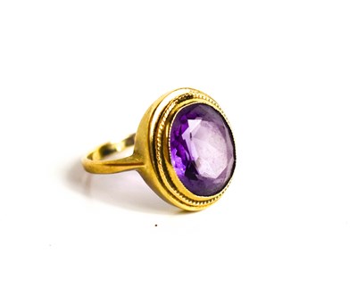 Lot 328 - A 9ct gold and amethyst ring, oval cut with...