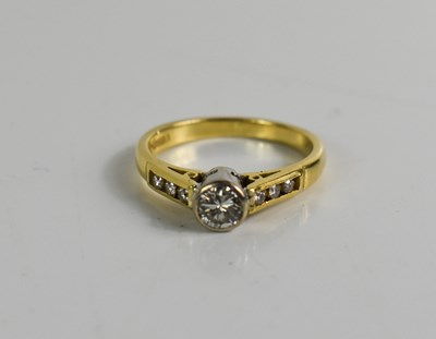 Lot 365 - An 18ct gold and diamond ring, the central...