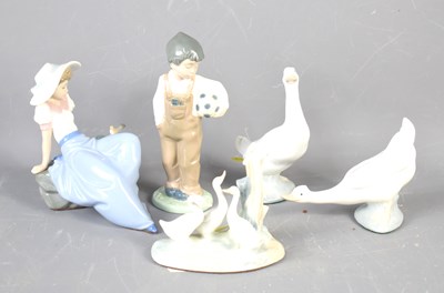 Lot 200 - A group of Lladro figurines to include a boy...