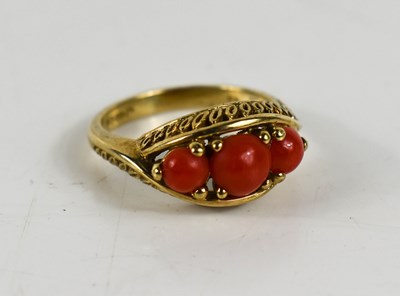 Lot 10 - A 9ct gold and coral three stone ring.