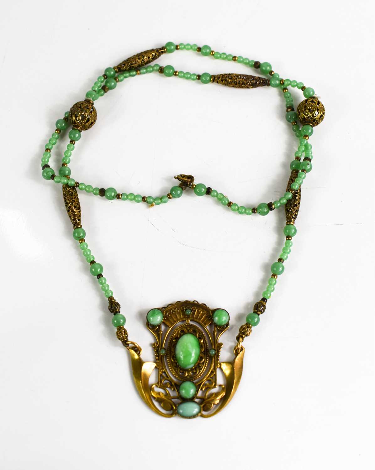 Lot 18 - An Art Noveau style jade and gold coloured...
