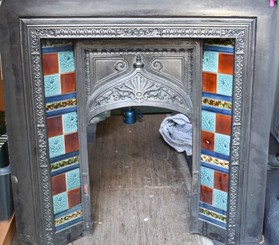 Lot 566 - A cast iron fireplace with tile inset, circa...