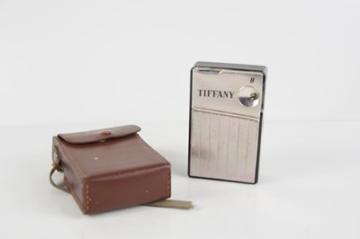 Lot 61 - A vintage Tiffany 8 transistor radio in the...