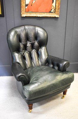 Lot 561 - A green leather button back armchair, with...