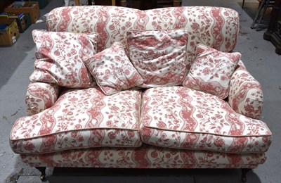 Lot 585 - A two seater sofa in the style of Howard and...