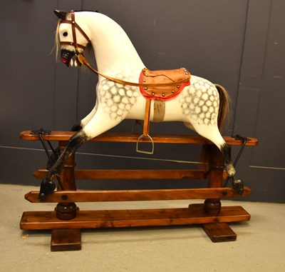 Lot 285 - A vintage rocking horse on a pine stained base....