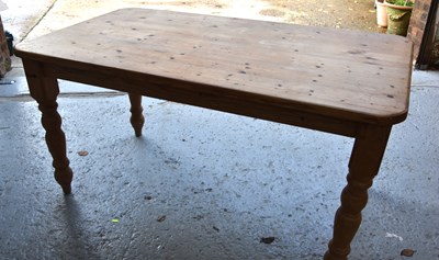 Lot 567 - A pine dining table with rectangular top and...