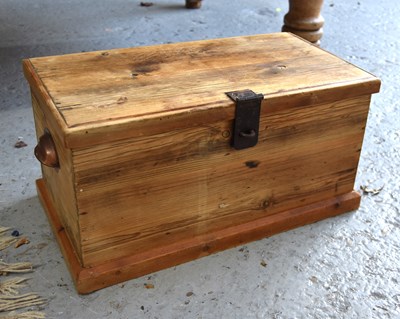 Lot 556 - A small pine chest with cup handles to the...