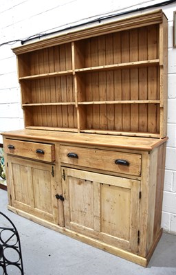 Lot 578 - A large antique pine dresser and rack, the...