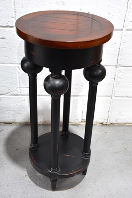 Lot 542 - A modern ebonised occasional table with boldly...