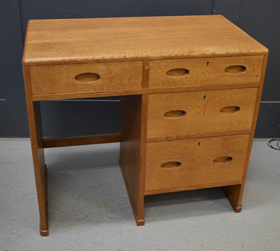 Lot 551 - A small Heals oak desk, composed of a bank of...