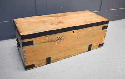 Lot 571 - An antique pine and iron clad blanket chest.