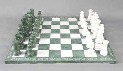 Lot 56 - A green and white marble chess board and pieces.
