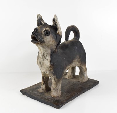 Lot 17 - A clay stoneware sculpture of a standing dog...